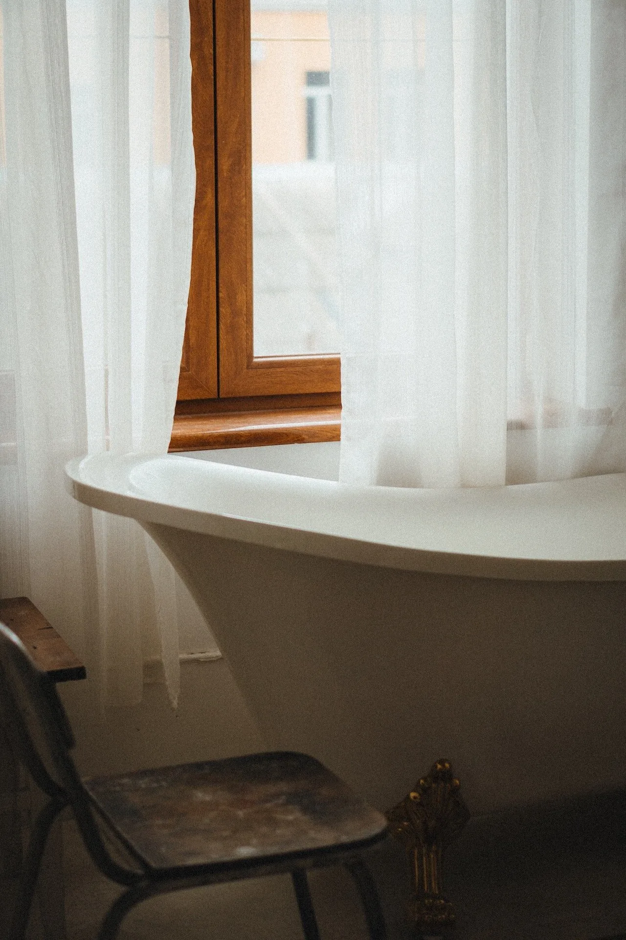 Freestanding bath in warm window light
