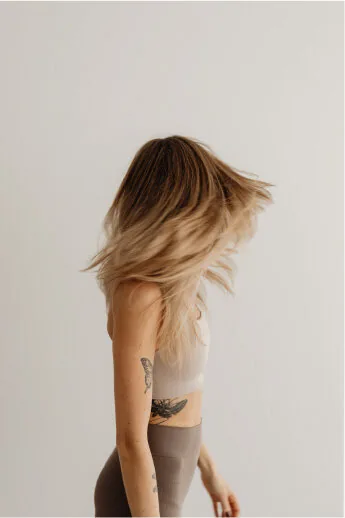 Woman with hair swept over her shoulder, seen from behind