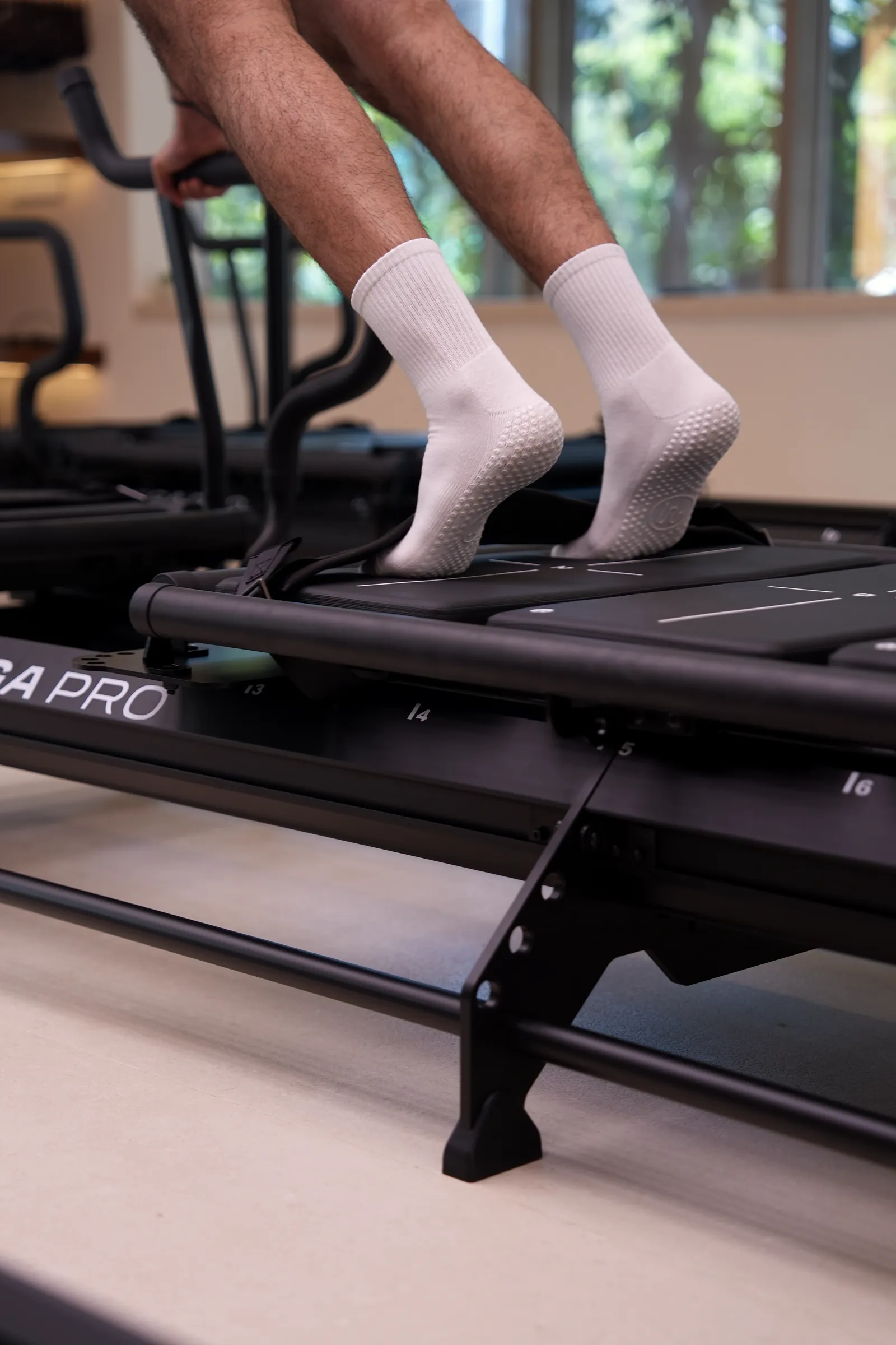 Grip socks on a Megaformer carriage in the Lagree studio