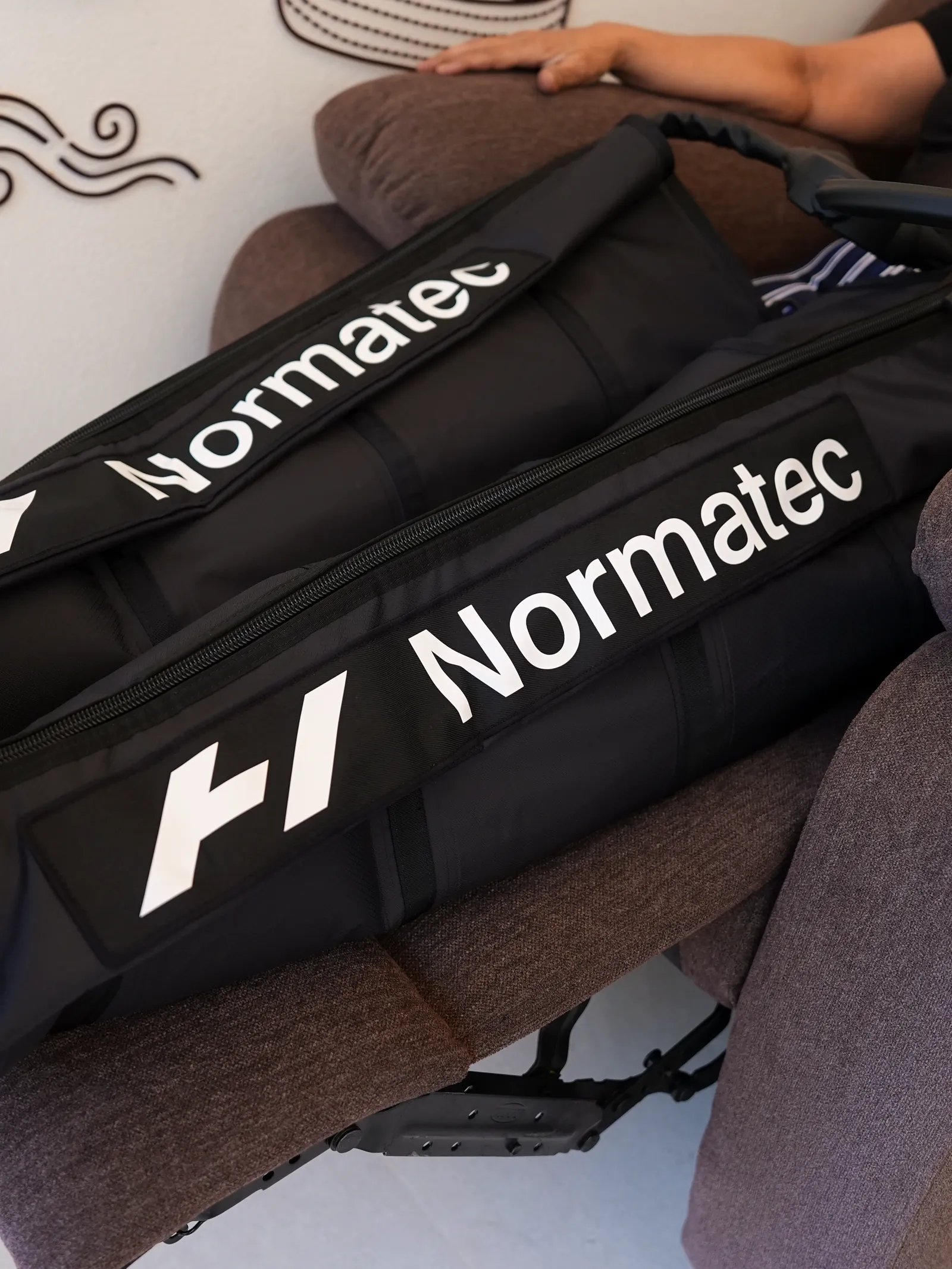Normatec compression boots resting on the recovery recliner