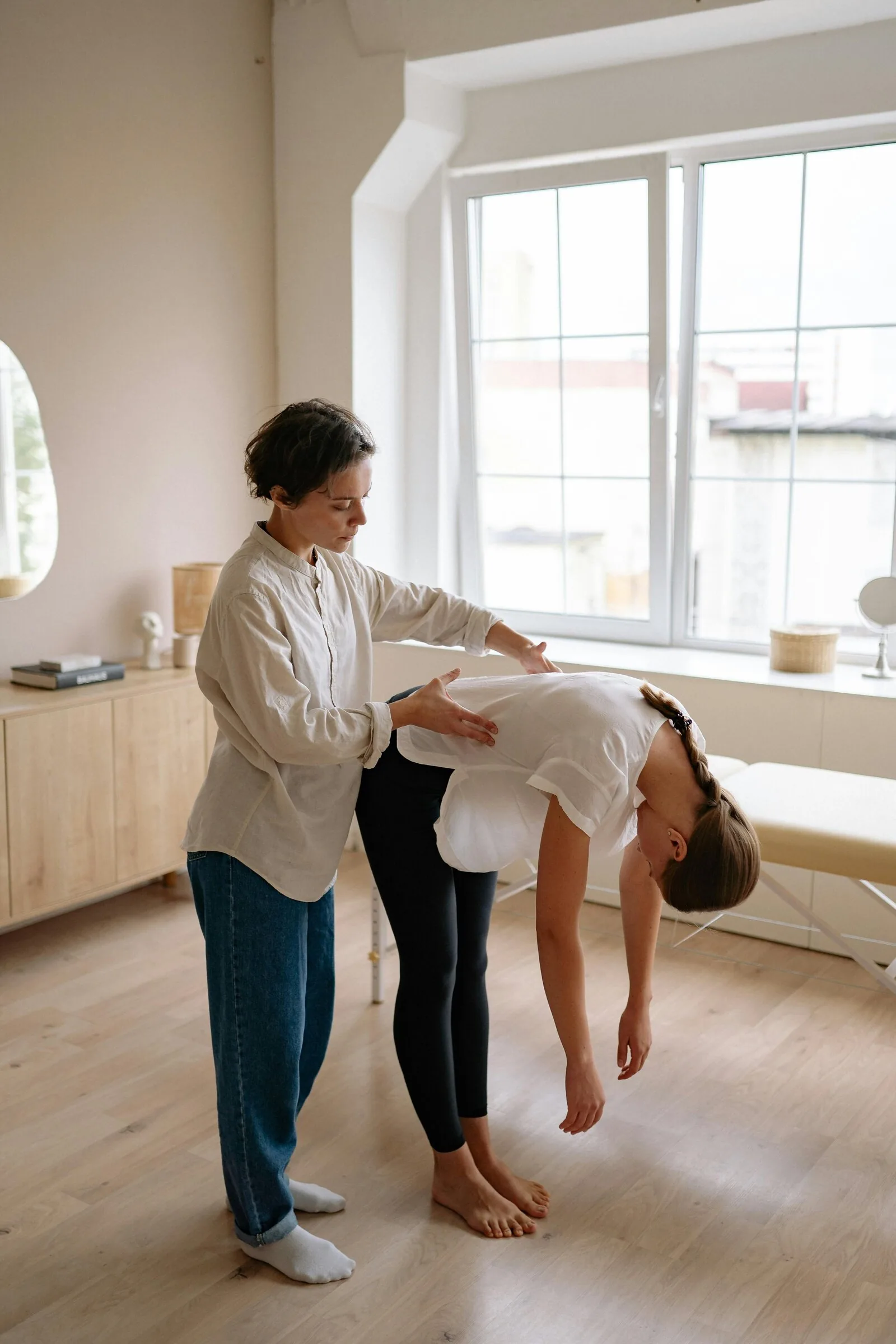 Osteopath guiding a patient through an assessment